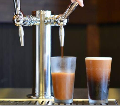 Nitro cold brew coffee being poured from tap, showcasing the velvety texture and cascading effect of nitrogen-infused cold brew.